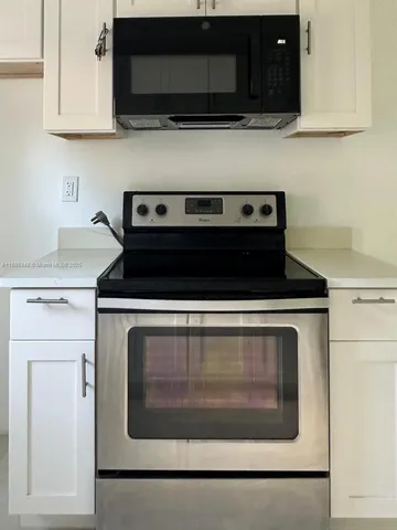a stove top oven sitting inside of a kitchen
