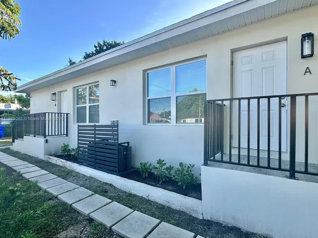 a view of a house with wooden fence