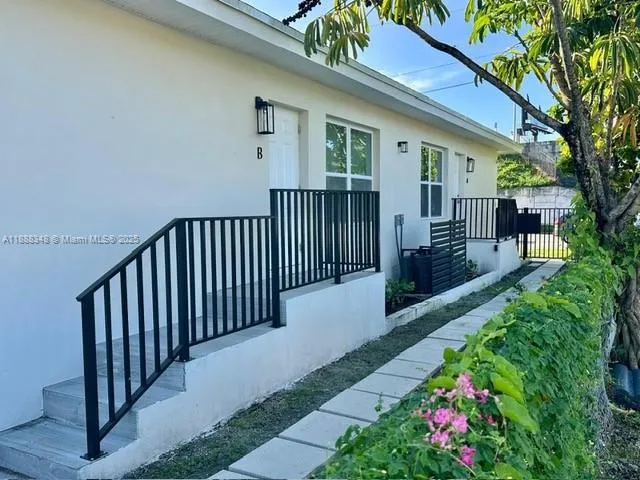a view of a house with wooden fence