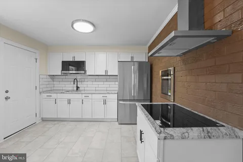 a kitchen with a sink stainless steel appliances and cabinets