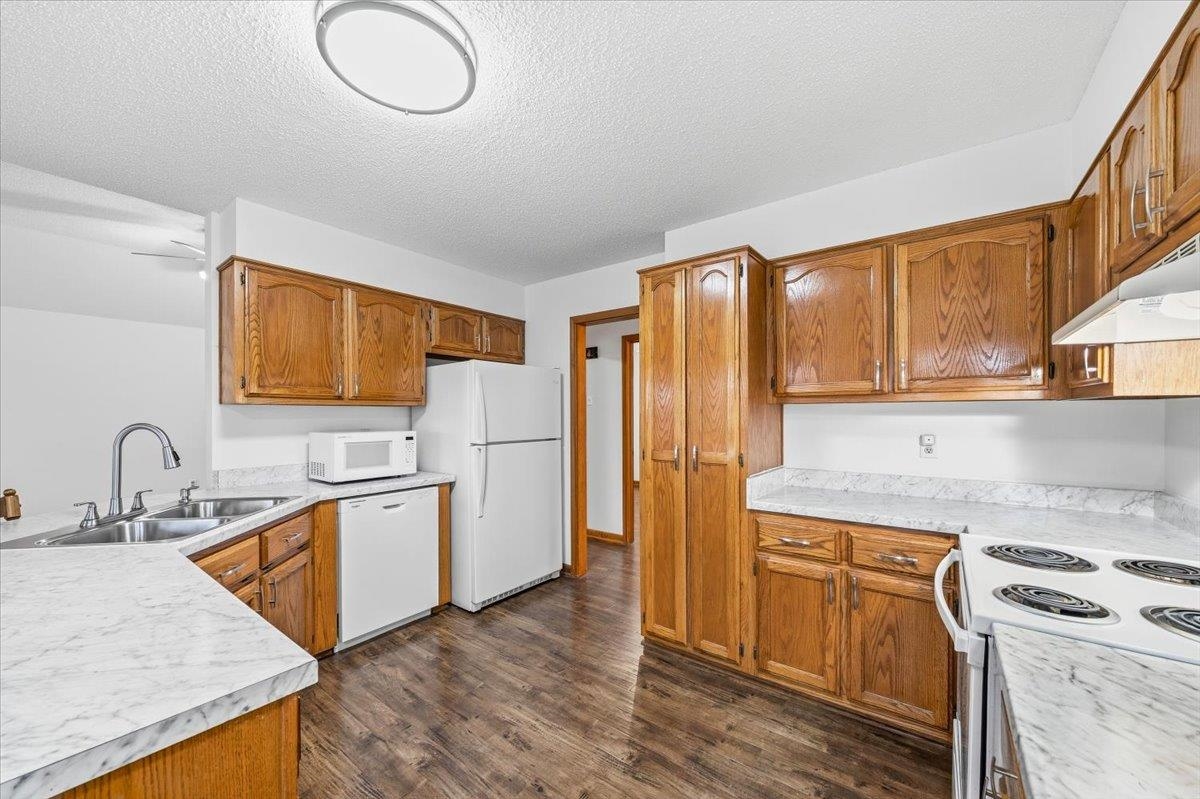1426 Simmons Road Drummonds, TN 38023 - Photo 13 of 29 a kitchen with stainless steel appliances granite countertop a sink stove and refrigerator