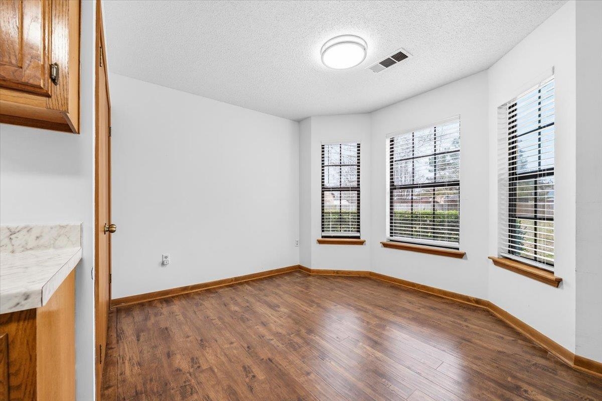 1426 Simmons Road Drummonds, TN 38023 - Photo 14 of 29 a view of an empty room with a window and wooden floor