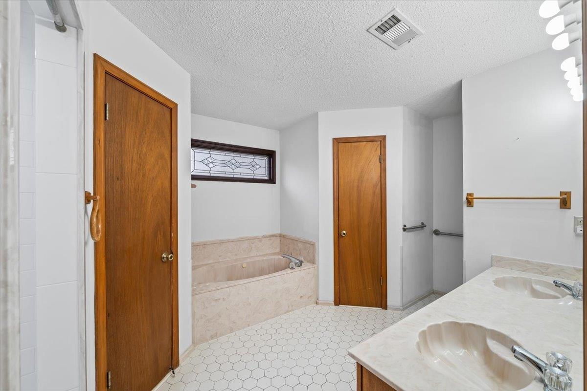 1426 Simmons Road Drummonds, TN 38023 - Photo 17 of 29 a bathroom with a tub and a sink