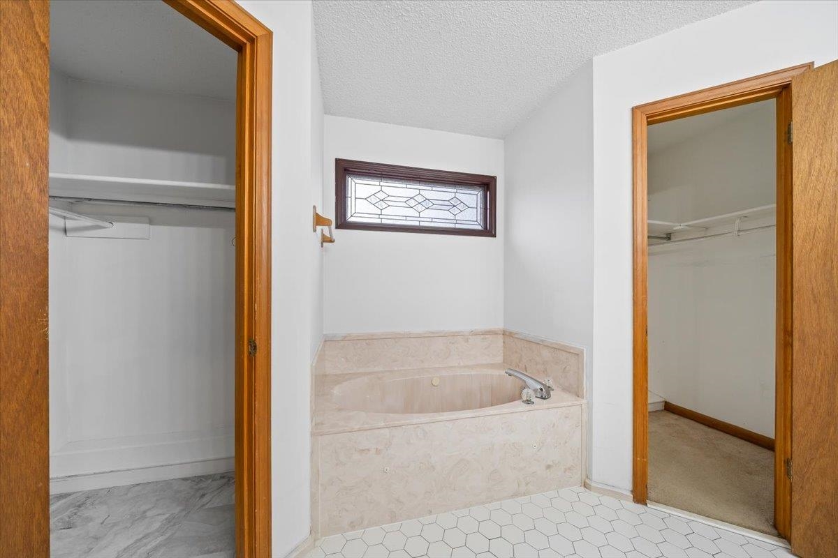 1426 Simmons Road Drummonds, TN 38023 - Photo 20 of 29 a white bath tub sitting next to a shower