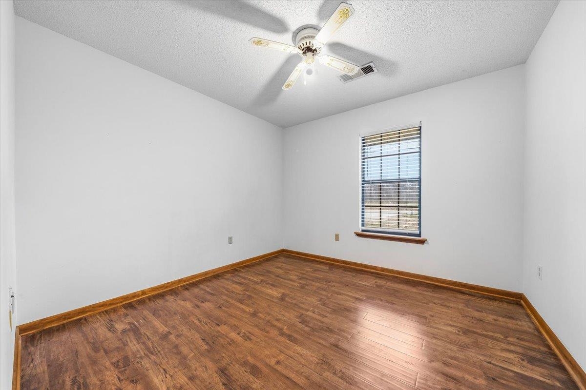 1426 Simmons Road Drummonds, TN 38023 - Photo 21 of 29 wooden floor in an empty room with a window