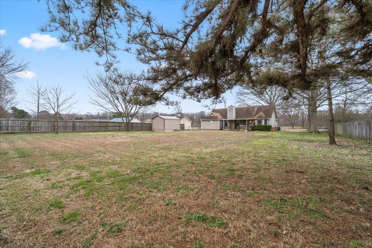 1426 Simmons Road Drummonds, TN 38023 - Photo 29 of 29 a view of a yard with a house in the background