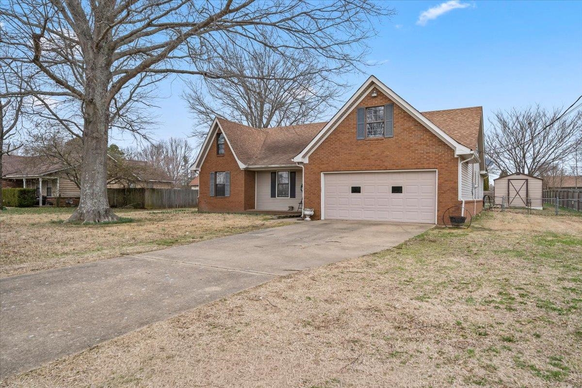 1426 Simmons Road Drummonds, TN 38023 - Photo 3 of 29 a house with trees in front of it