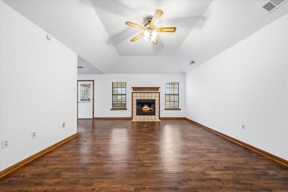 1426 Simmons Road Drummonds, TN 38023 - Photo 7 of 29 wooden floor in an empty room with a fireplace