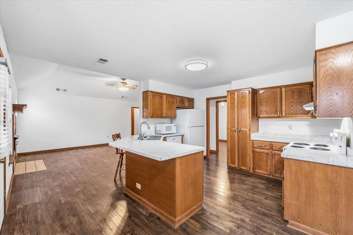 1426 Simmons Road Drummonds, TN 38023 - Photo 10 of 29 a kitchen with a sink a stove a refrigerator and cabinets