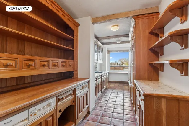 a kitchen with granite countertop a sink and a refrigerator