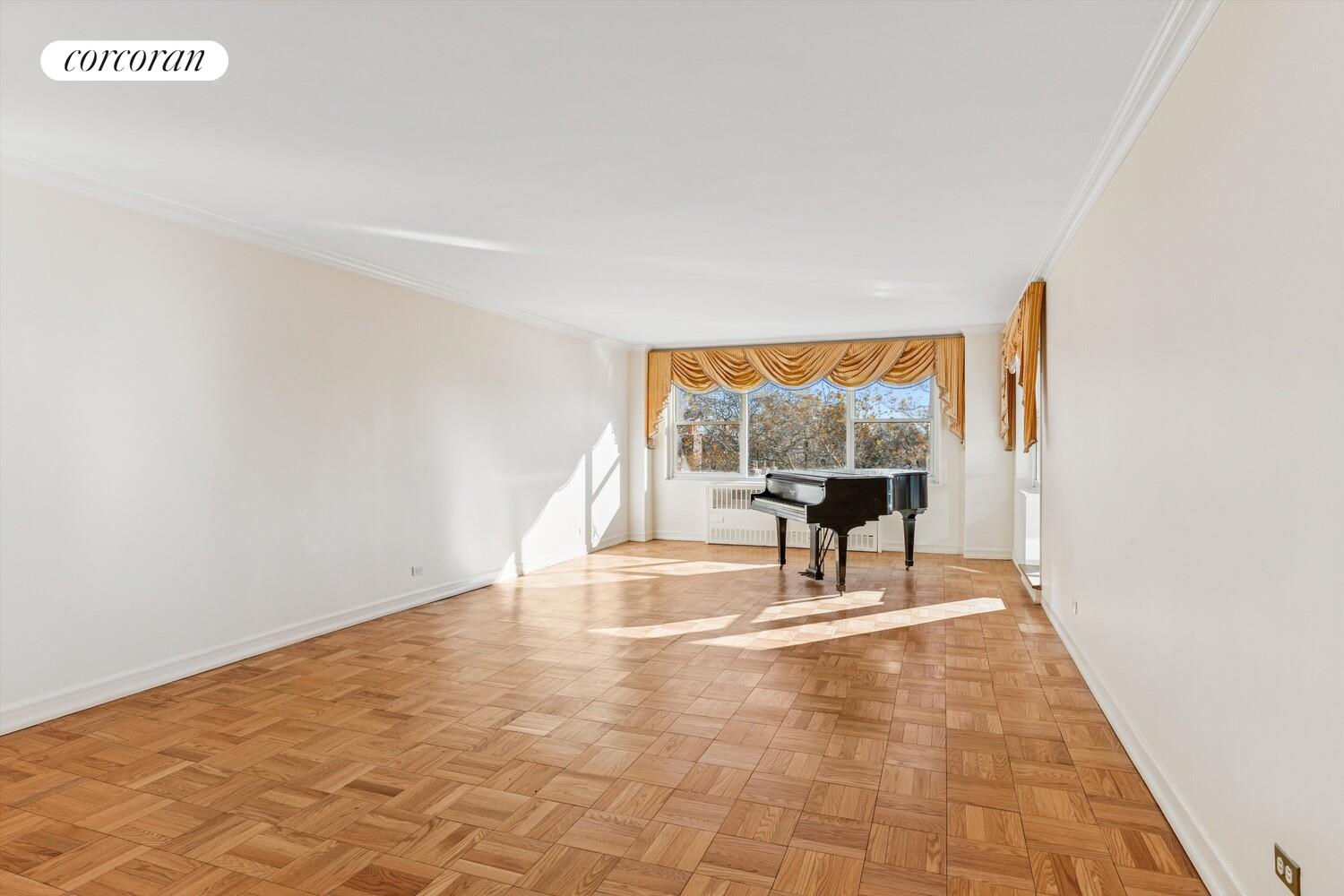 535 East 86th Street, Unit 6F Manhattan, NY 10028 - Photo 12 of 22 a view of empty room with wooden floor and floor to ceiling window