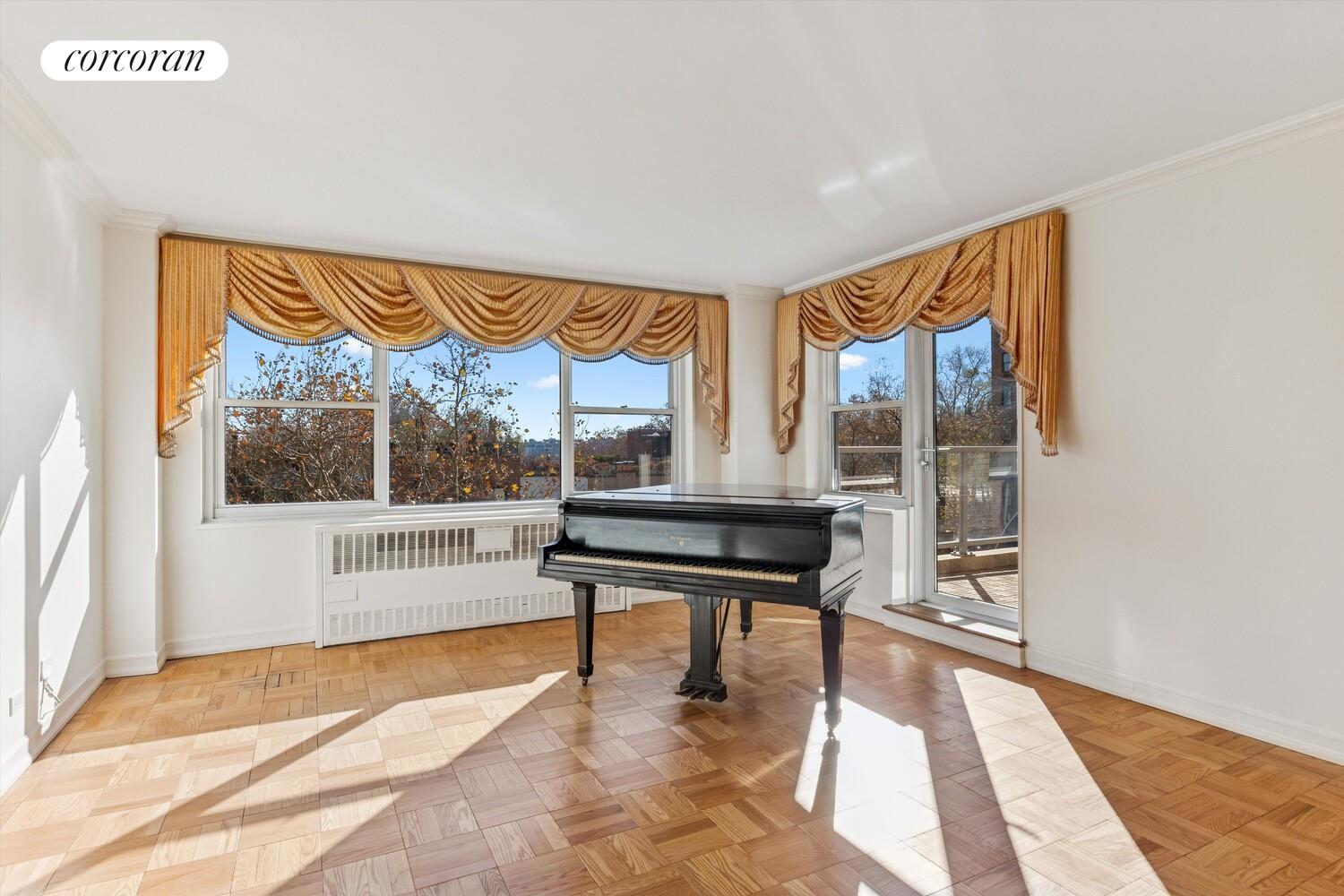 535 East 86th Street, Unit 6F Manhattan, NY 10028 - Photo 13 of 22 a living room with a large window and a table