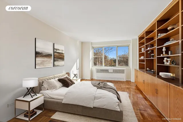 a bedroom with a large bed and a potted plant