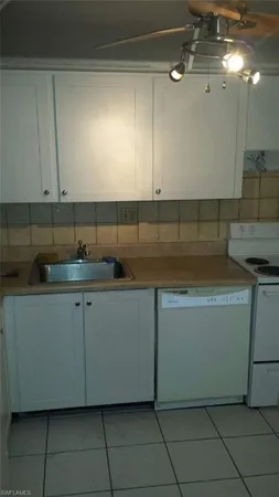 a kitchen with a sink and cabinets