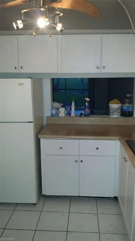 a kitchen with a refrigerator and cabinets