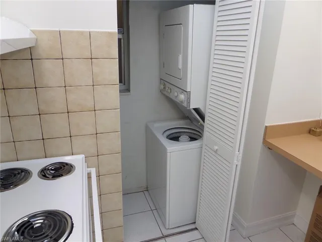 a bathroom with a sink and a washer dryer