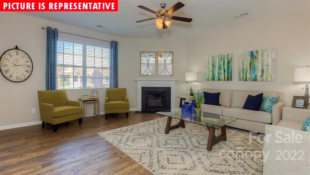 104 Kona Road Mooresville, NC 28117 - Photo 11 of 38 a living room with furniture a rug and a fireplace