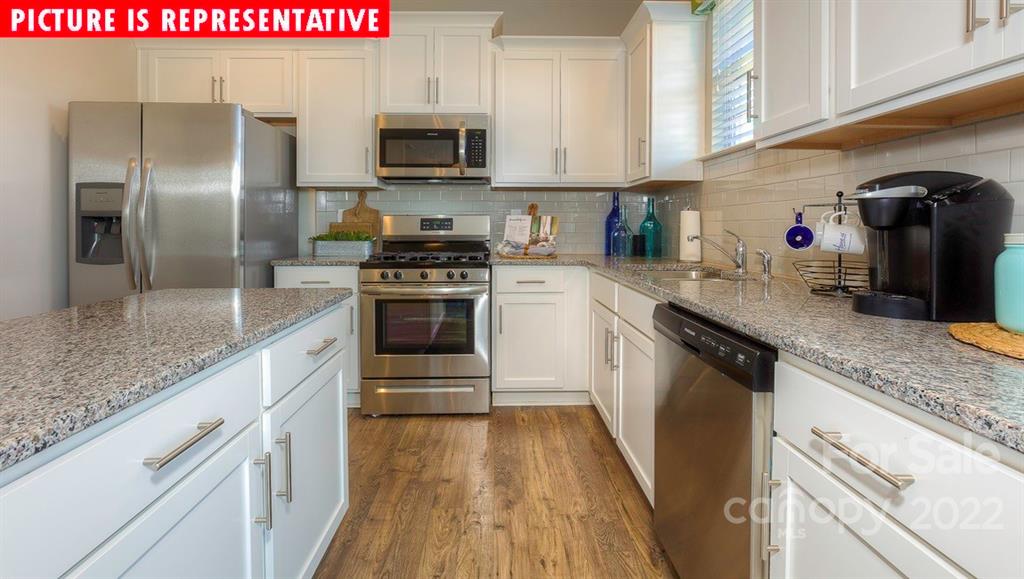 104 Kona Road Mooresville, NC 28117 - Photo 17 of 38 a kitchen with stainless steel appliances granite countertop a sink a stove and refrigerator