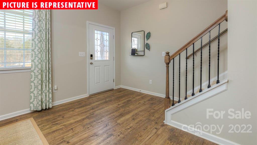 104 Kona Road Mooresville, NC 28117 - Photo 2 of 38 a view of a hallway with wooden floor and windows