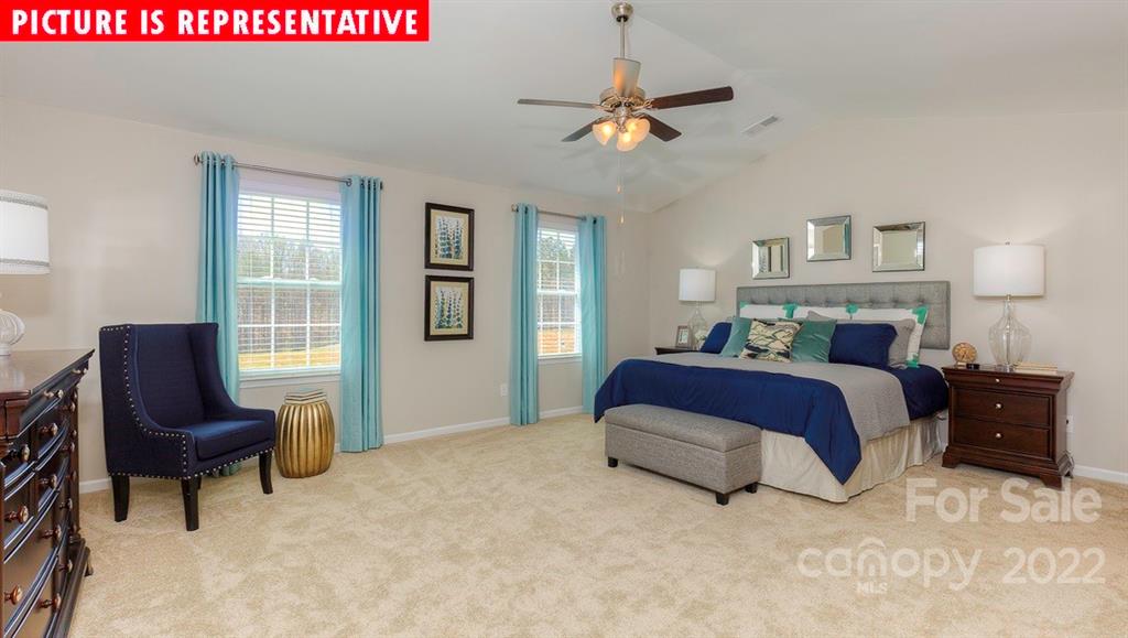 104 Kona Road Mooresville, NC 28117 - Photo 24 of 38 a spacious bedroom with a bed and a chair