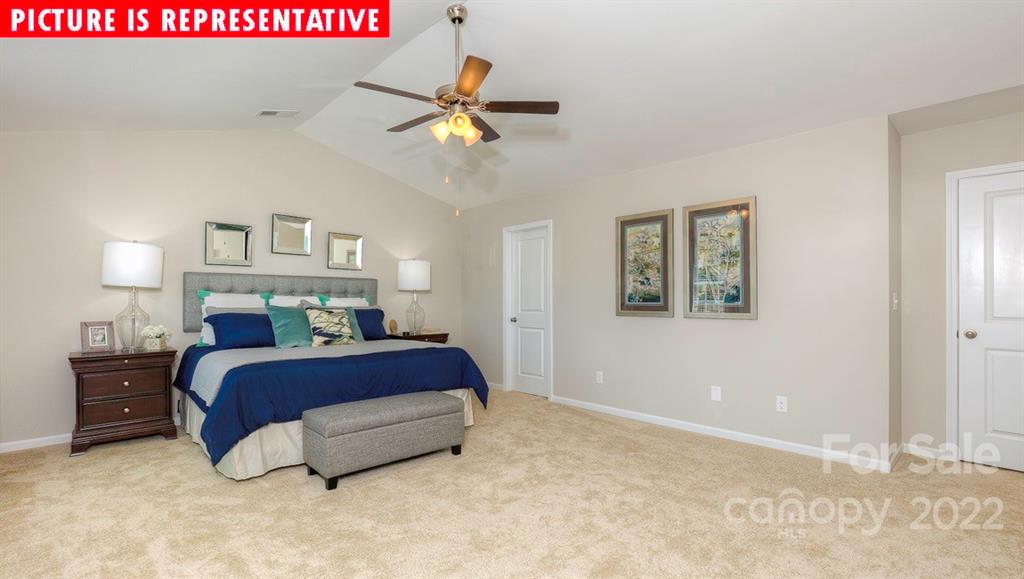 104 Kona Road Mooresville, NC 28117 - Photo 25 of 38 a spacious bedroom with a bed and a chandelier
