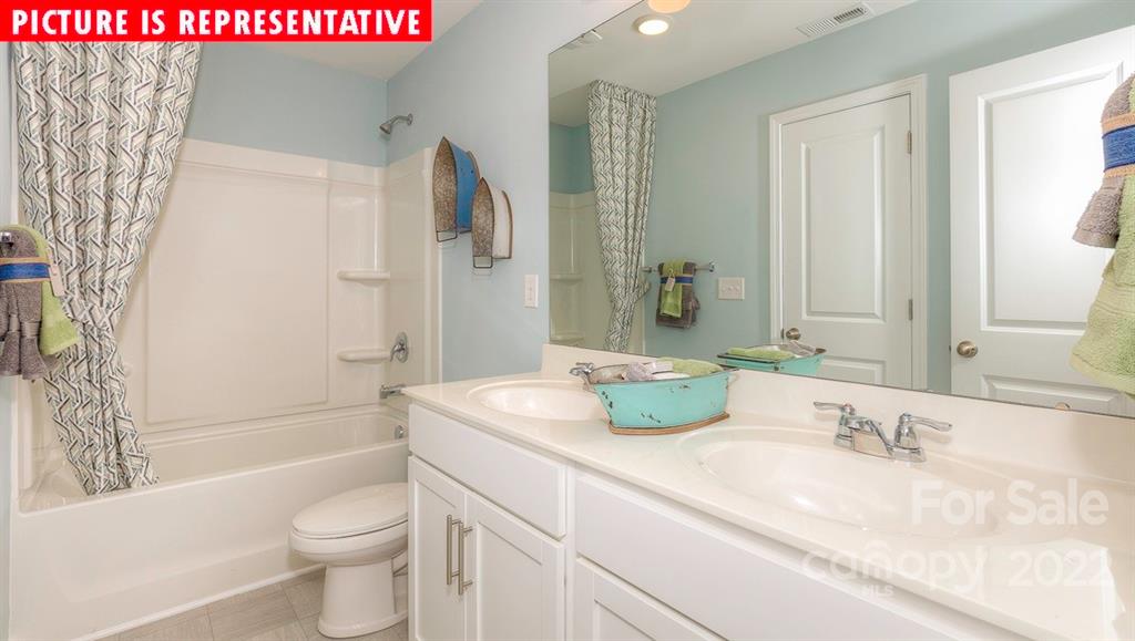 104 Kona Road Mooresville, NC 28117 - Photo 34 of 38 a bathroom with a granite countertop sink mirror vanity and toilet