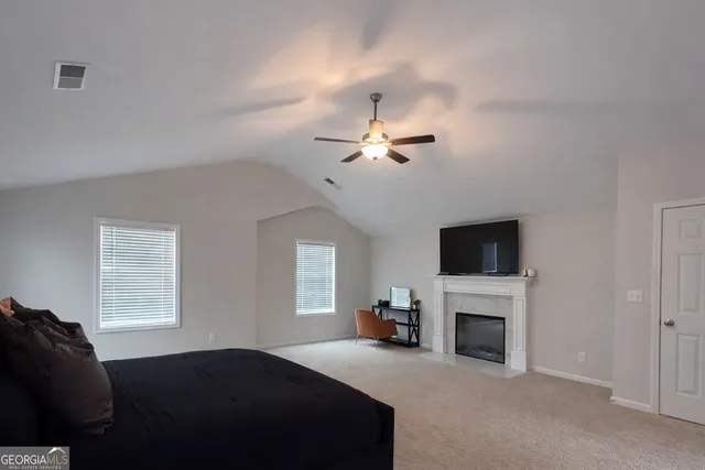 a living room with fireplace furniture and a flat screen tv