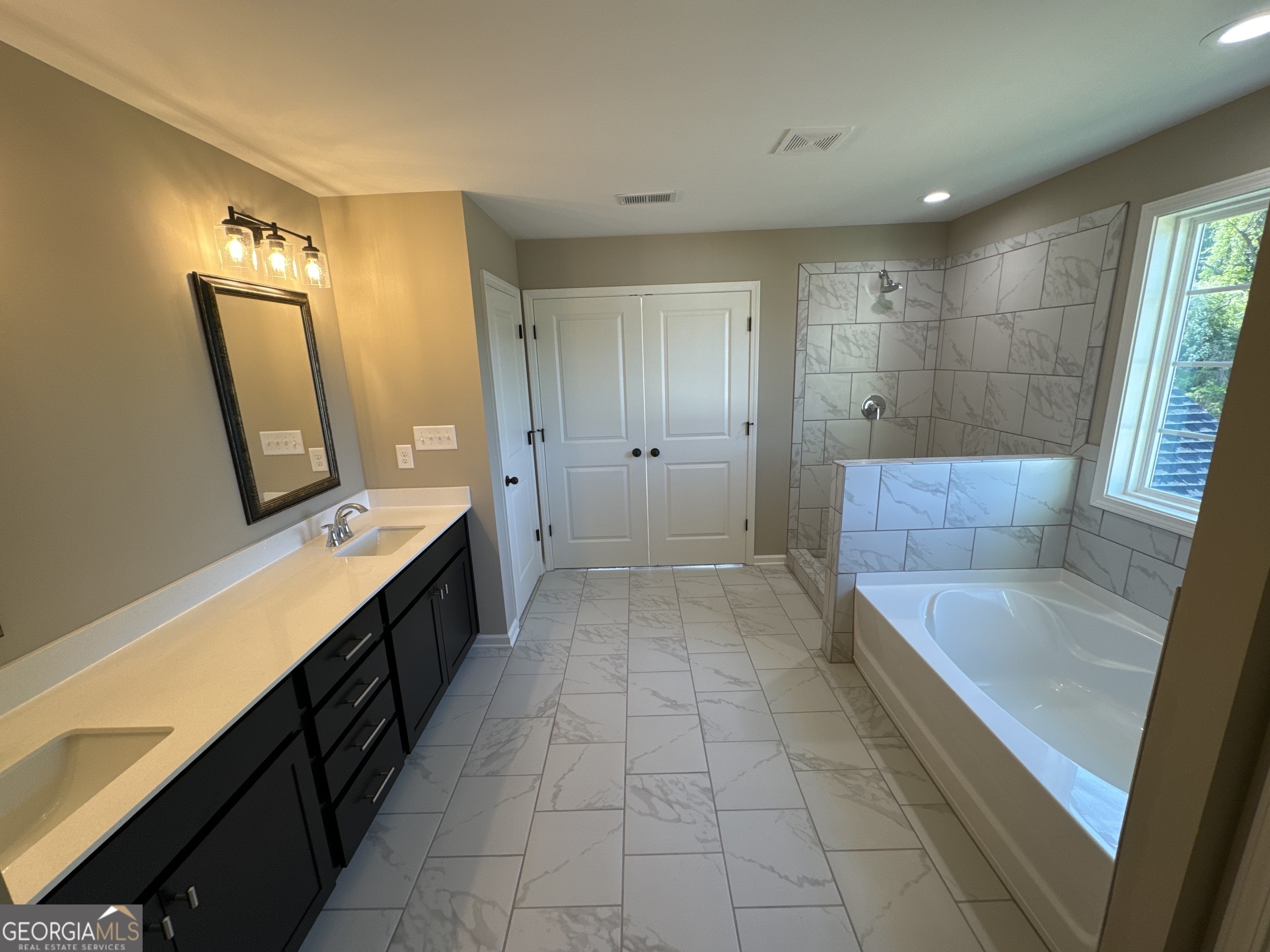 4355 Cornwall Drive Forsyth, GA 31029 - Photo 13 of 23 a bathroom with a tub sink and mirror