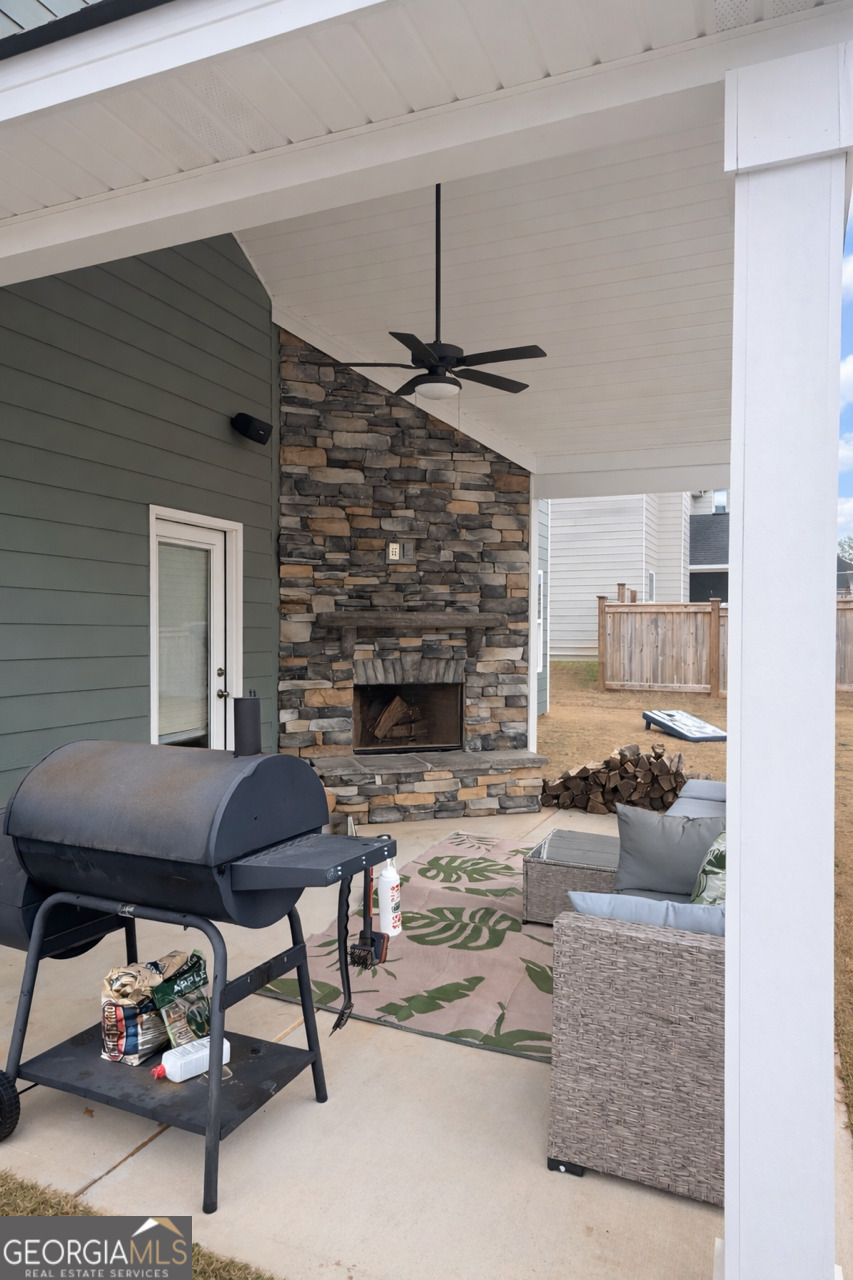 4355 Cornwall Drive Forsyth, GA 31029 - Photo 21 of 23 a living room with furniture and a fireplace