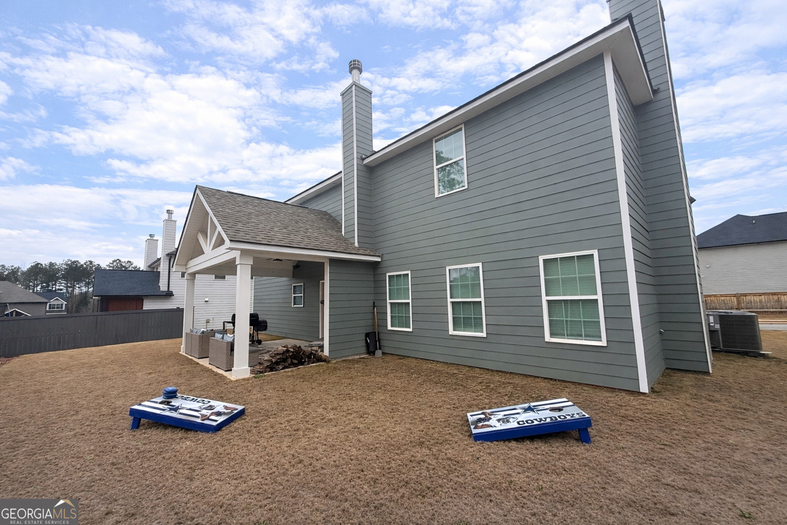 4355 Cornwall Drive Forsyth, GA 31029 - Photo 22 of 23 a backyard of a house with a barbeque oven and countertop lots of windows