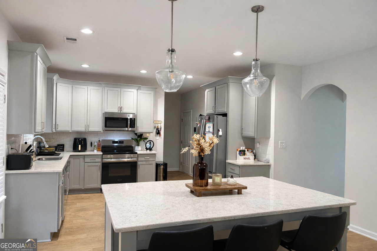 4355 Cornwall Drive Forsyth, GA 31029 - Photo 7 of 23 a kitchen with refrigerator a stove and a sink