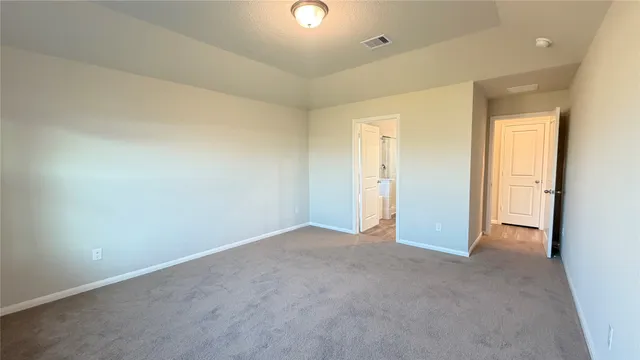 an empty room with closet and windows