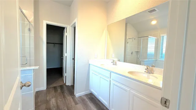 a bathroom with a double vanity sink and mirror