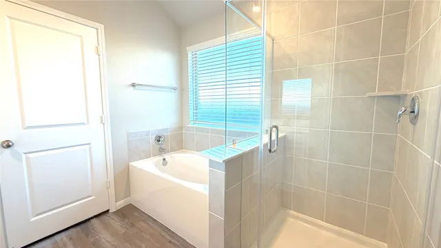 a bathroom with a bathtub and a shower