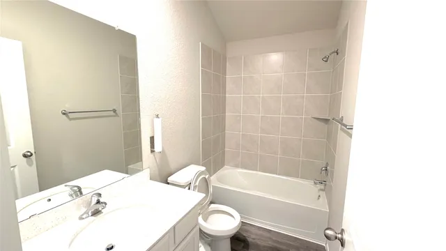 a bathroom with a sink a toilet and bathtub