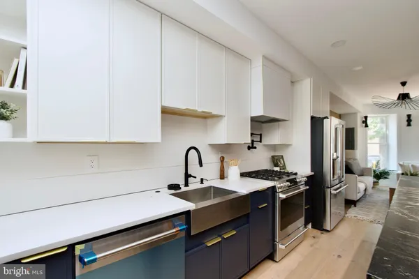 a kitchen with a sink cabinets and stainless steel appliances