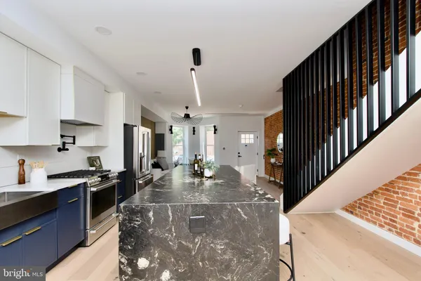 a kitchen with sink refrigerator and cabinets