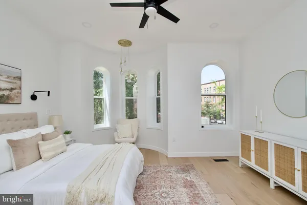 a bedroom with a bed a dresser and a window