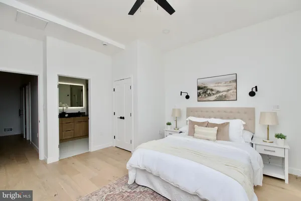 a bedroom with a bed and a painting on the wall