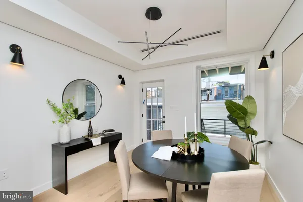 a living room with furniture a chandelier and a table