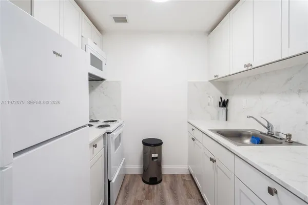 a kitchen with a sink and cabinets
