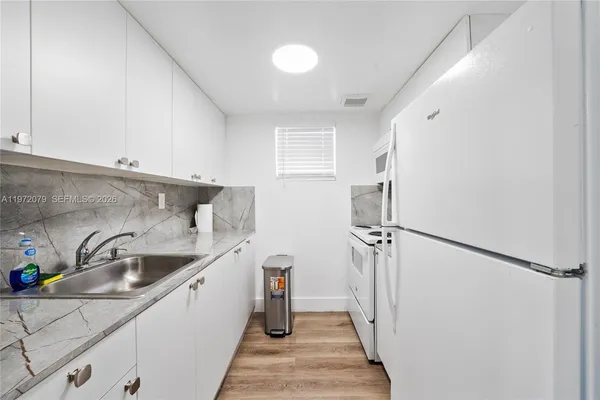 a kitchen with a sink and refrigerator