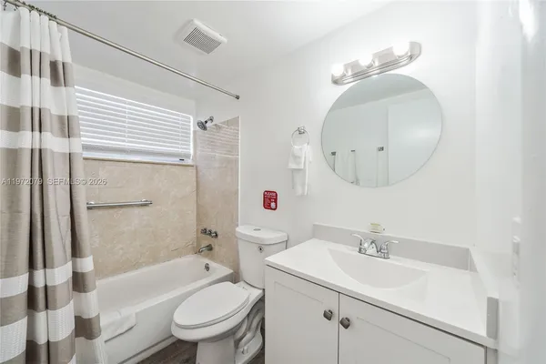 a bathroom with a sink toilet tub and shower