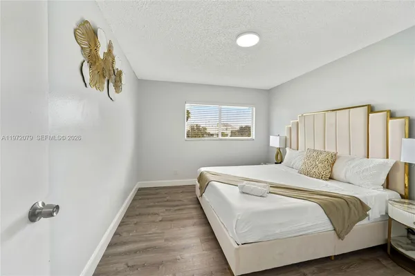 a bedroom with a bed and painting on the wall