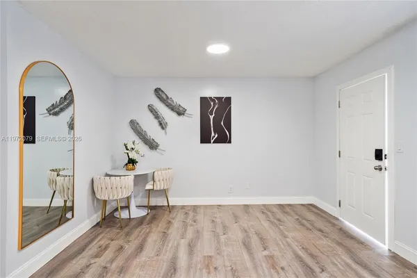 a view of a bedroom with wooden floor and a sink