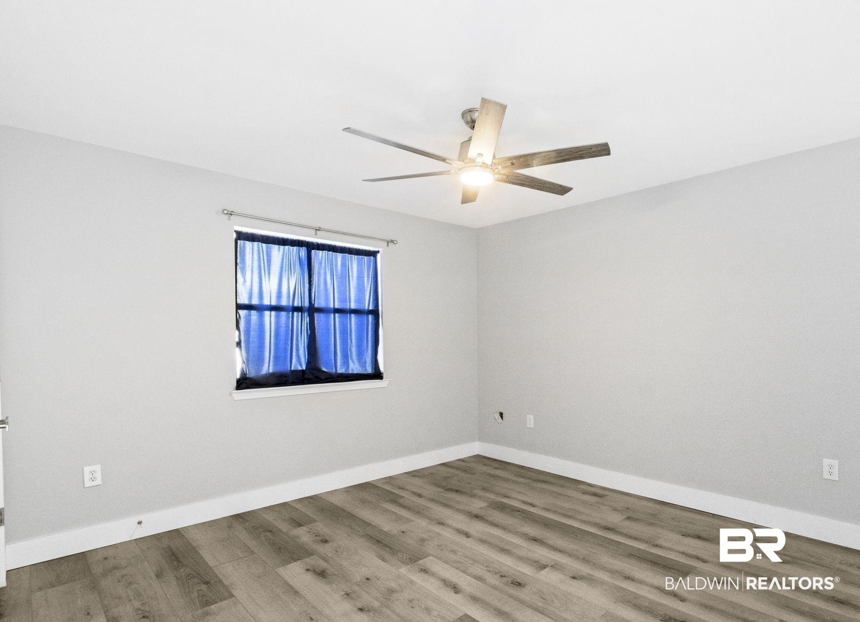 25861 Canal Road, Unit 77 Orange Beach, AL 36561 - Photo 27 of 48 Spare room featuring wood finished floors and a ceiling fan