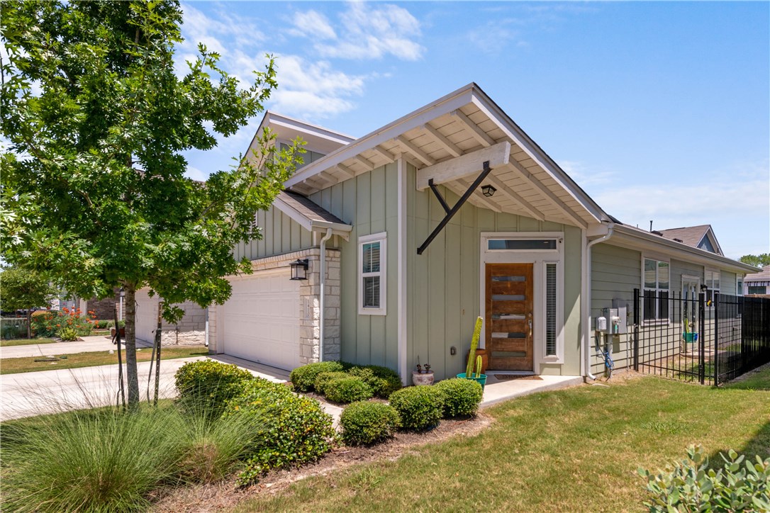 1410 Homespun Road Austin, TX 78745 - Photo 1 of 1 a front view of a house with a yard