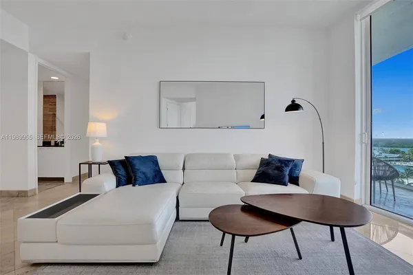 a living room with furniture and a lamp