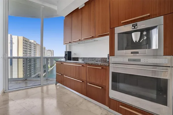 a kitchen with granite countertop a stove sink and cabinets
