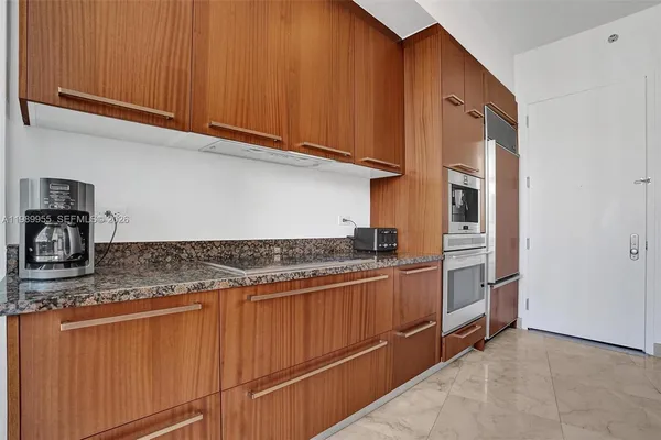 a kitchen with stainless steel appliances granite countertop a stove and a refrigerator